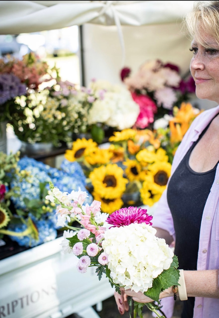 Colorful flower market buckets overflowing with blooms